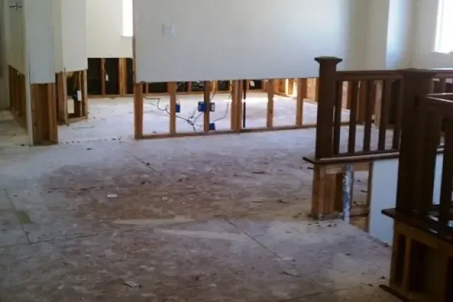 Rooms opened up with the lower drywall cut away while structural drying runs