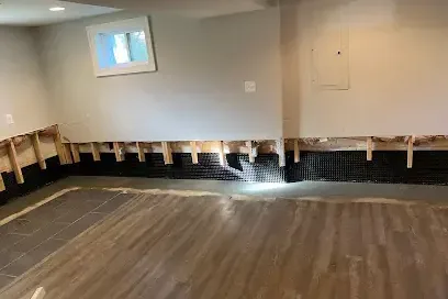Finished basement with the flooring pulled and the wall bottoms cut open after a flood